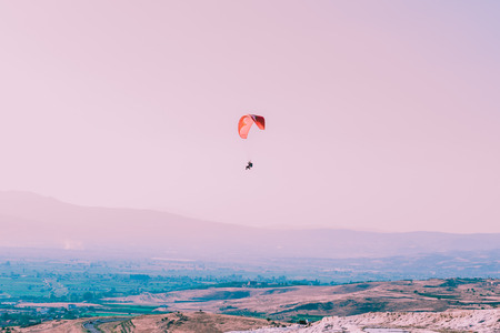 Turquoise color view of Pamukkale (Cotton Castle) is popular with Travertine pools and terraces  and a paraglide on the air.の写真素材