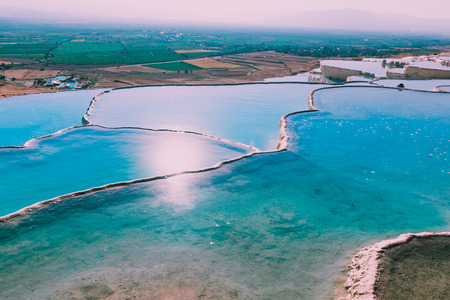 Turquoise color view of Pamukkale (Cotton Castle) is popular with Travertine pools and terraces  where people love to visit in Pamukkale, Turkey.の写真素材