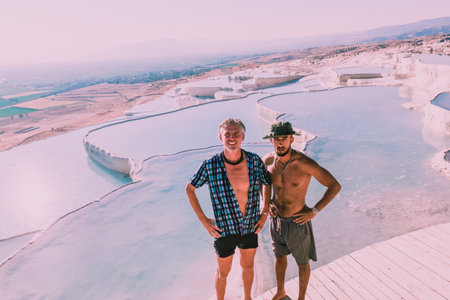 Unidentified people poses for a camera at Pamukkale (Cotton Castle) that is popular with Travertine pools and terraces  where people love to visit in Pamukkale, Turkey.25 August 2017のeditorial素材