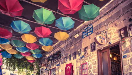 Street view of Alacati district of Cesme.Alacati  is a popular destination for traveling and vacation.Colorful umbrellas hanging for decoration  Izmir,Turkey.26 August 2017.のeditorial素材