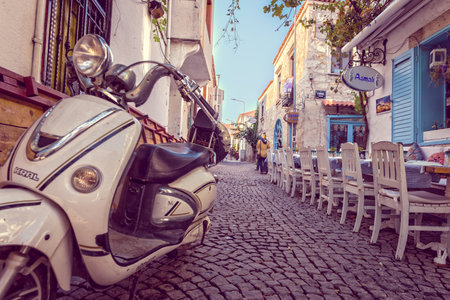 Street view of Alacati district of Cesme.A motorcycle on the foreground.Alacati  is a popular destination for traveling and vacation in Izmir,Turkey.26 August 2017.のeditorial素材