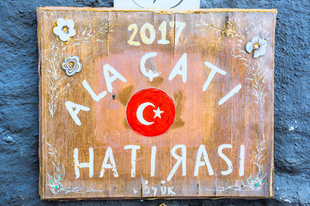 Wooden handmade decorated layer with Turkish flag and Alacati Hatirasi (Alacati Memory) is written on it.Summer vacation concept in Alacati,Turkey.のeditorial素材