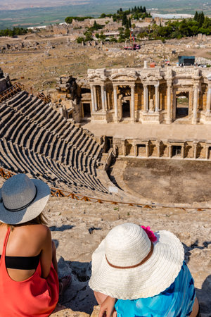 Unidentified women watch the ruins of Antique Theater in ancient Greek city Hierapolis, Pamukkale, Turkey.25 August 2017のeditorial素材