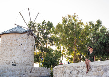 People visit ancient old stone windmills on a sunny day in Alacati town, a popular destination for traveling and holiday in Izmir,Turkey.26 August 2017.のeditorial素材