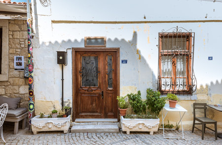 Retro,Vintage View of a village house wooden door with  different kind ornaments for decoration around it.Alacati,Turkey.のeditorial素材
