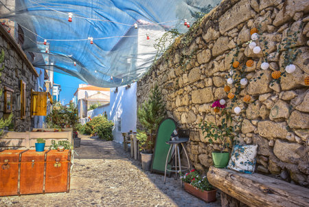 HDR Image-Unidentified people walking at Alacati charming Streets , a popular destination for traveling and vacation in Izmir,Turkeyのeditorial素材
