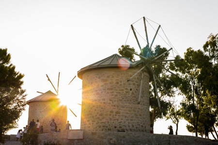 People visit ancient old stone windmills on a sunny day in Alacati town, a popular destination for traveling and holiday in Izmir,Turkey.26 August 2017.のeditorial素材