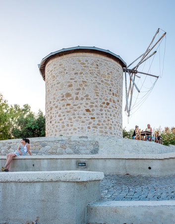 People visit ancient old stone windmills on a sunny day in Alacati town, a popular destination for traveling and holiday in Izmir,Turkey.26 August 2017.のeditorial素材