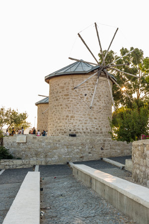 People visit ancient old stone windmills on a sunny day in Alacati town, a popular destination for traveling and holiday in Izmir,Turkey.26 August 2017.のeditorial素材