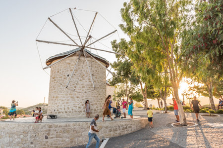 People visit ancient old stone windmills on a sunny day in Alacati town, a popular destination for traveling and holiday in Izmir,Turkey.26 August 2017.のeditorial素材