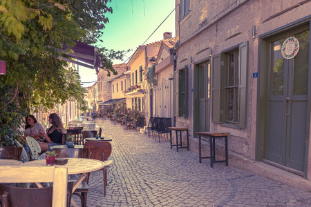 HDR Image-Unidentified woman chatting in a cafe at Alacati charming Streets , a popular destination for traveling and vacation in Izmir,Turkey.26 August 2017.のeditorial素材