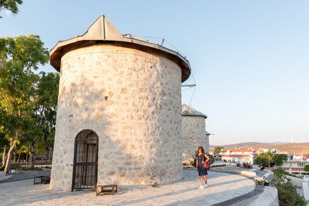 People visit ancient old stone windmills on a sunny day in Alacati town, a popular destination for traveling and holiday in Izmir,Turkey.26 August 2017.のeditorial素材