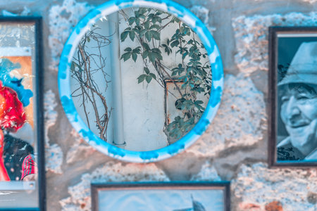 Frames with photos of famous Turkish people and places on white wall and a vintage lamp in Izmir,Turkey.26 August 2017.のeditorial素材