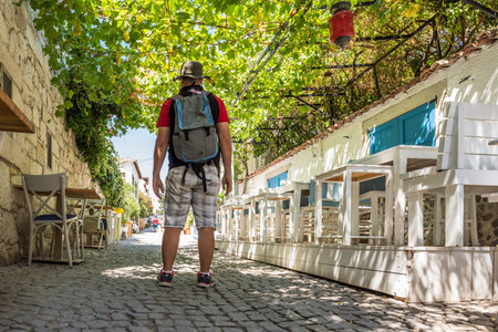 Man walking at Alacati charming Streets , a popular destination for traveling and vacation in Izmir,Turkey.26 August 2017.のeditorial素材