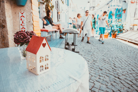 Retro Photo Filter Effect-View of a cafe table and a decoration with a rose in a glass at Alacati Streets , a popular destination for traveling and vacation in Izmir,Turkey.26 August 2017.のeditorial素材
