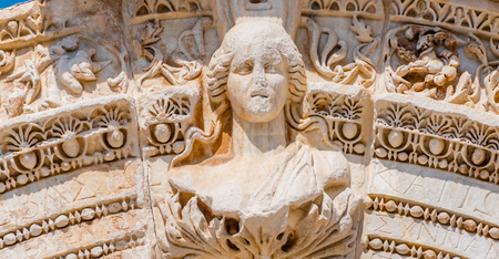Marble reliefs in Ephesus historical ancient city, in Selcuk,Izmir,Turkey.Figure of Medusa with ornaments of Acanthus leaves,Detail of the Temple of Hadrian.の写真素材