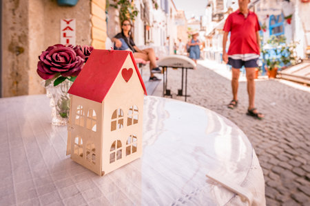 Retro Photo Filter Effect-View of a cafe table and a decoration with a rose in a glass at Alacati Streets , a popular destination for traveling and vacation in Izmir,Turkey.26 August 2017.のeditorial素材