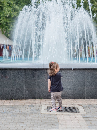 Unidentified child walks around pool at Orhangazi Square in Bursa City center.Bursa,Turkey.20 May 2018のeditorial素材