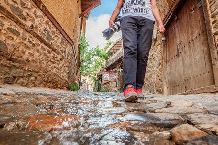 Unidentified man walks at street of Cumalikizik village,a popular destination for Tourists and locals in Bursa,Turkey.20 May 2018のeditorial素材