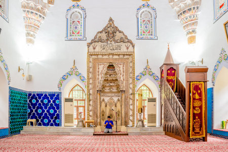 Unidentified man prays at Murat II mosque at Muradiye complex or Complex of Sultan Murat II in...