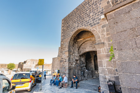 Unidentified people walk around historical gate named as Mardin gate in sur region in central of Diyarbakir,Turkey.16 July 2018のeditorial素材