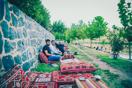 Unidentified people sit near ten eyed bridge,a popular landmark in central of Diyarbakir,Turkey.16...