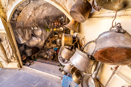View of a shop with lots of copper coffee pots on foreground for sale in Mardin,Turkey.17 June 2018