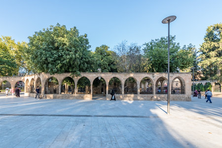 Unidentified people walk at courtyard of Balikli Gol(fish lake) in Sanliurfa city center.Sanliurfa,Turkey.18 July 2018のeditorial素材