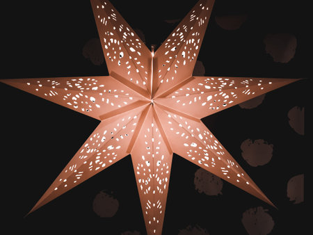 View of large big star decorated with light bulbs on a dark background for Christmas