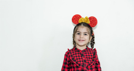 Adorable lovely little girl in funny crown with funny face.Concept with isolated background.の写真素材