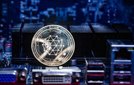 Front view of Qtum cryptocurrency over computer video card.Bitcoin mining farm concept.の写真素材