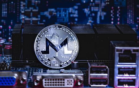 Front view of Monero cryptocurrency over computer video card.Bitcoin mining farm concept.の写真素材