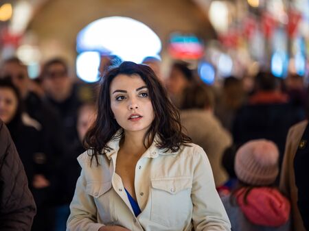 Portrait of beautiful woman in fashionable modern clothes stands among people in grand Bazaar,Istanbul,Turkey.Modern women lifestyle business or travel tourist conceptの写真素材