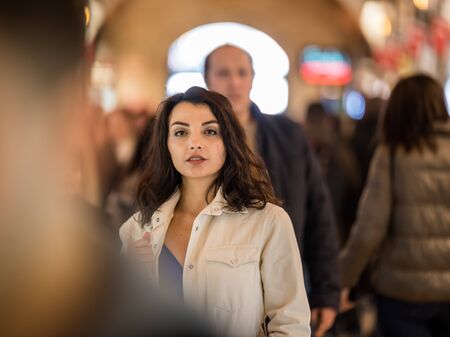 Portrait of beautiful woman in fashionable modern clothes stands among people in grand Bazaar,Istanbul,Turkey.Modern women lifestyle business or travel tourist conceptの写真素材