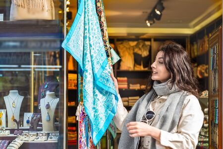 Beautiful traveler woman looks at traditional Turkish desserts sold a store in Istanbul,Turkey.Traveler woman  lifestyle Concept.の写真素材