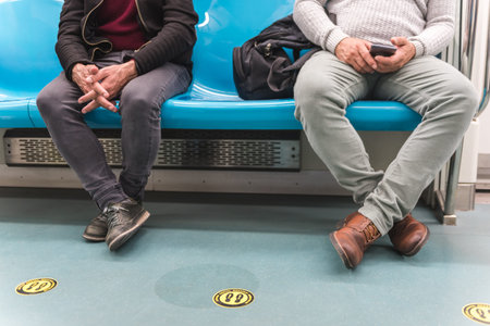 Social distancing.View of the legs of two men who are standing and separated by a distance.Yellow...