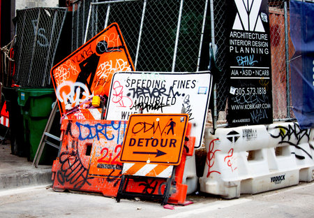 Miami, Florida August 29, 2018 Commercial Construction site with a bundle of Traffic sign with...