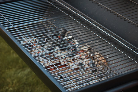 Black big barrel grill in the back garden.