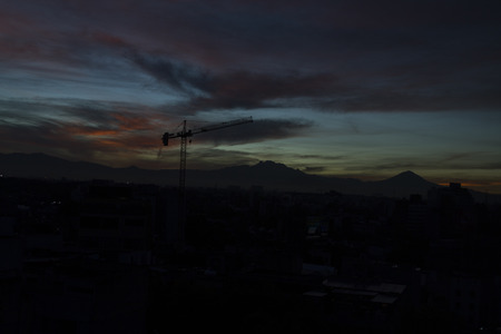 Sunrise view of the Popocatepetl volcano mountain rais above Mexico city.The city surrounded by mountains and volcanoes that reach elevations of over 5,000 meters.の写真素材
