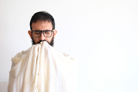 Bearded Jewish Man putting on a  Tallit (talis) Before preying