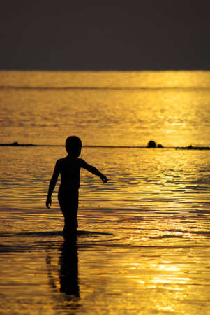 A boy wade into the sea, Chang Island, Trad, Thailandの写真素材