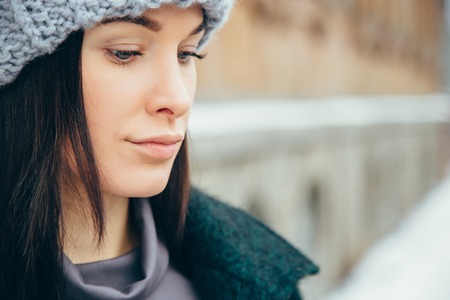 Young woman winter portrait. Beautiful Young Smiling Girl in her Winter Warm Clothing. Outdoor close up photo of young beautiful happy smiling girlの写真素材