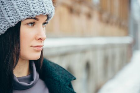 Young woman winter portrait. Beautiful Young Smiling Girl in her Winter Warm Clothing. Outdoor close up photo of young beautiful happy smiling girlの写真素材