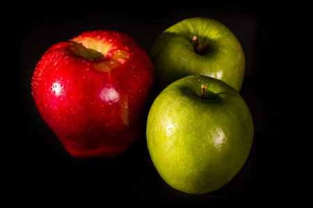 red and green apples isolated on black background