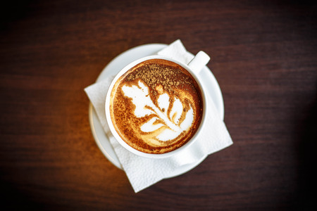 Hot coffee in a cup on wooden tableの写真素材