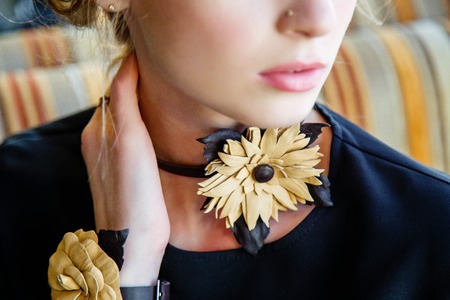 Close-up of handmade leather jewelry on a girlの写真素材