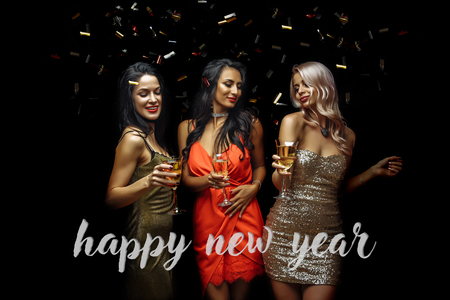Happy young women with glasses of champagne. Happy new yearの写真素材