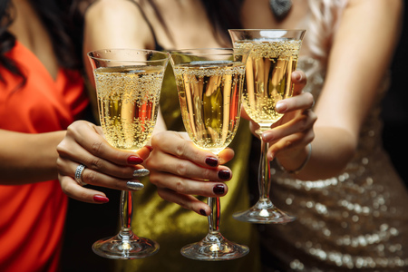 Women's hands with glasses of champagne. X-mas.の写真素材