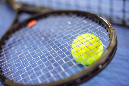 Tennis ball and racket on the tennis courtの写真素材