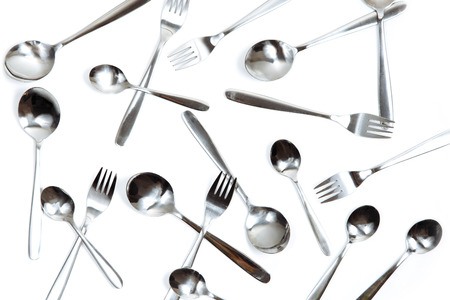 Many Cutlery spoons and forks on a white isolate.の写真素材
